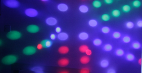 Pattern of coloured patches of light, created by disco lights.